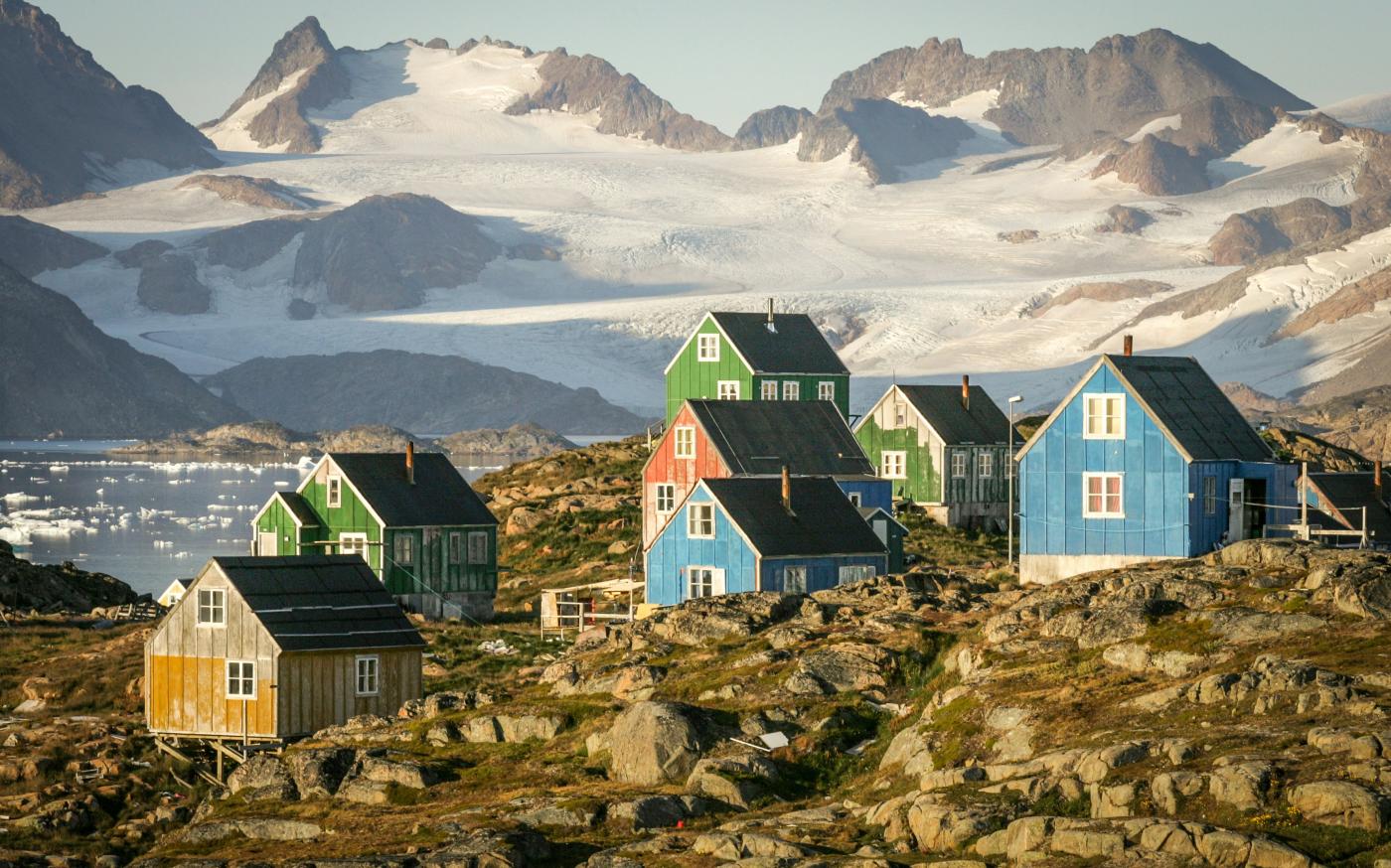 Colorful houses nestled in a rocky, mountainous landscape. by Nick Russill courtesy of Unsplash.