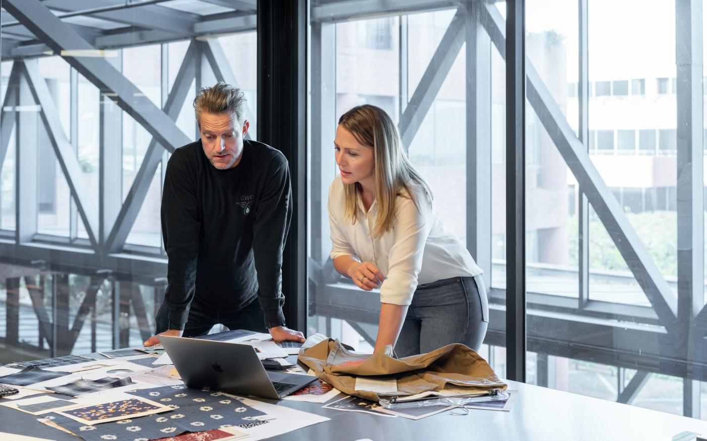 man and woman sitting at table by LinkedIn Sales Solutions courtesy of Unsplash.