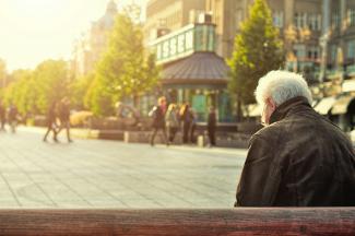 man sitting on brown wooden bench by Huy Phan courtesy of Unsplash.
