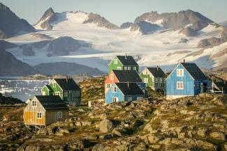 Colorful houses nestled in a rocky, mountainous landscape. by Nick Russill courtesy of Unsplash.
