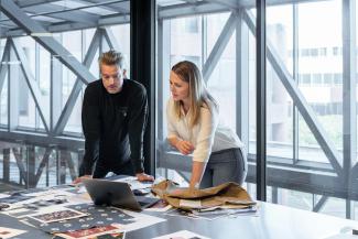 man and woman sitting at table by LinkedIn Sales Solutions courtesy of Unsplash.